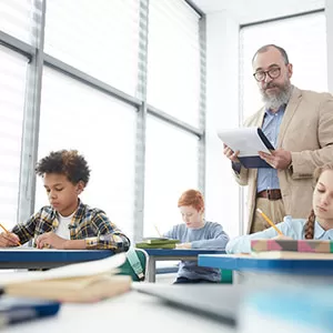 Student reading book in library wearing mask