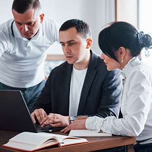Student reading book in library wearing mask